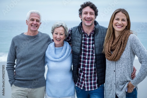 Cheerful family standing on shore at beach