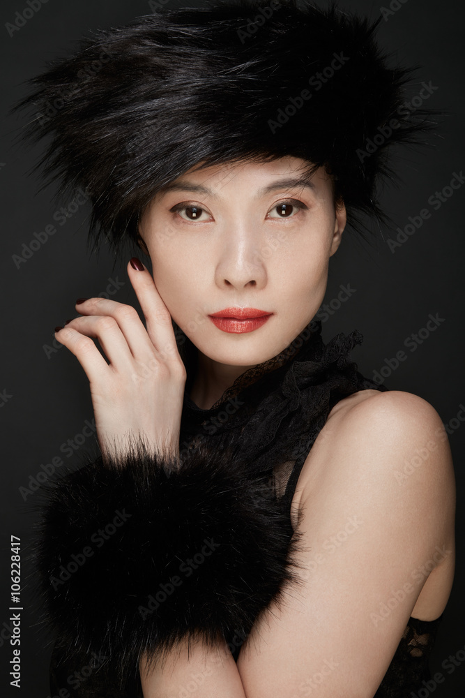 Beautiful asian woman make up shot with black fur hat and cuff Beautiful asian woman make up shot with black fur hat and cuff