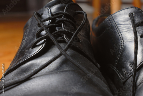 Black shoes lacing. Macro. photo