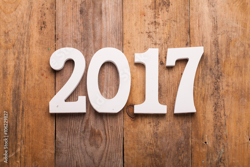 White word of 2017 on wooden background.