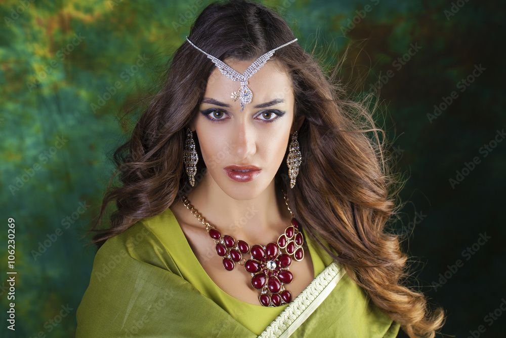 Fototapeta premium Young pretty woman in green indian dress