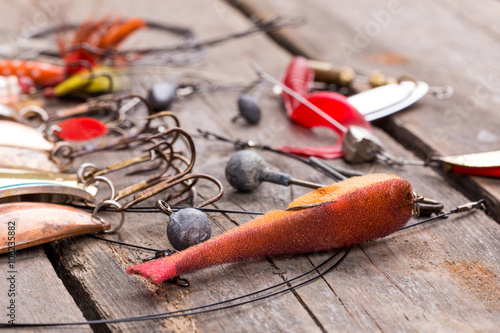 fishing tackles and spoon on wooden