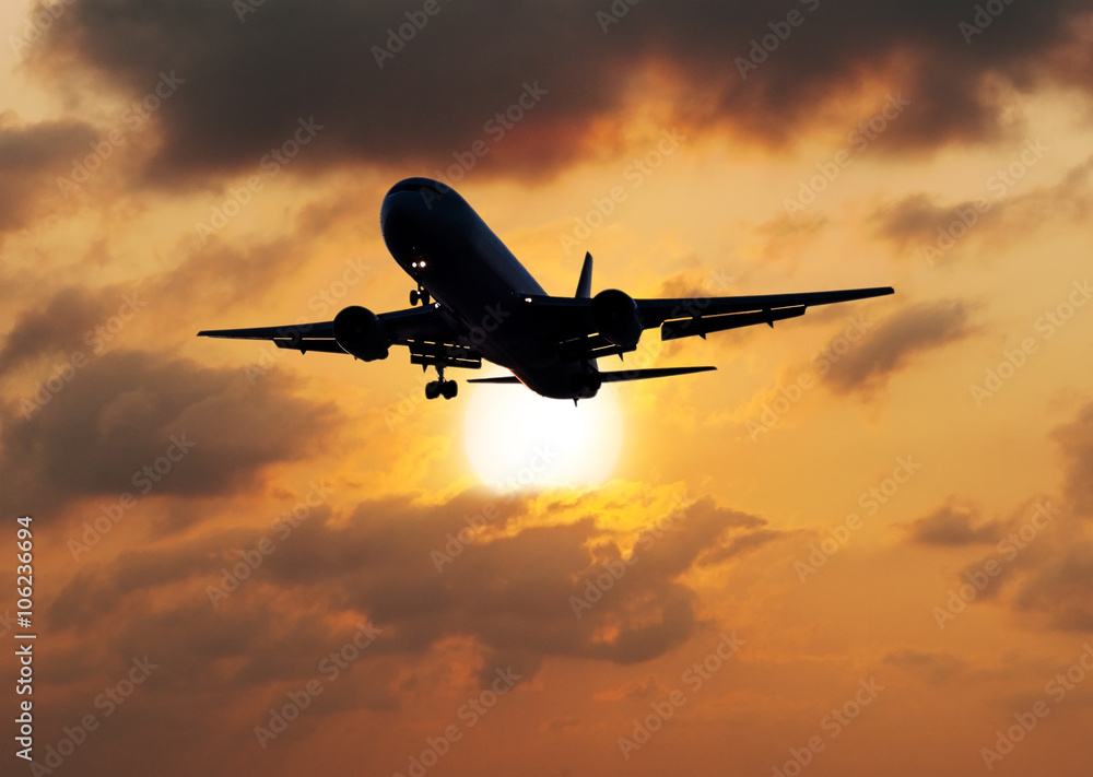 Silhouette airplane with the sun