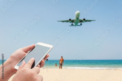 Blurred plane and blue sea with white sand beach