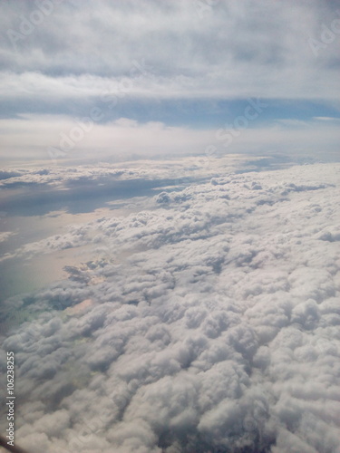 Scenic view of peaceful sky and clouds from an airplane window flying