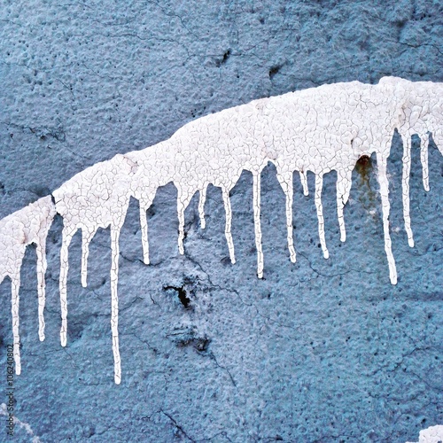 White drips on blue wall