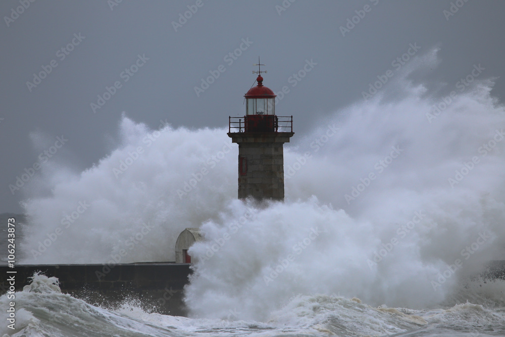 Storm with big waves near a lighthouse