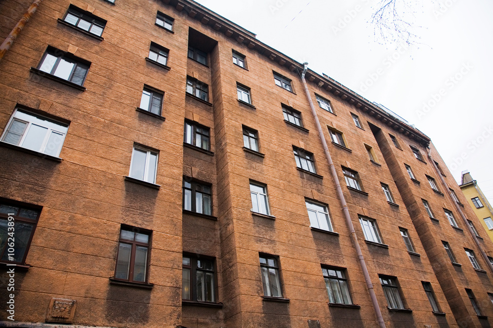 Facade of a multi-storey old house with windows