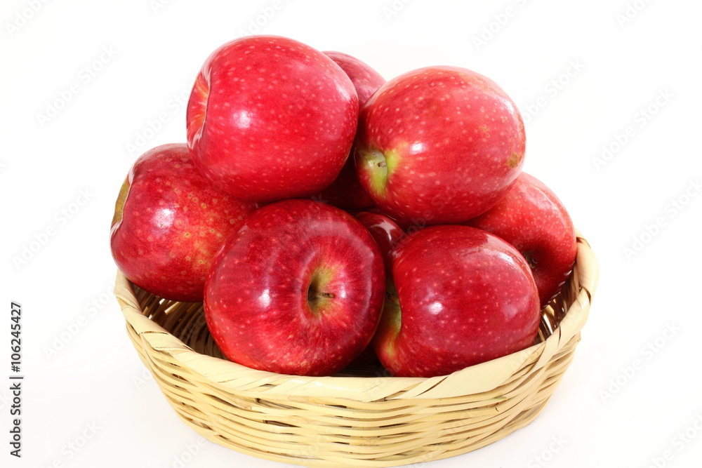 red apple in bamboo basket on white background red apple in bamboo basket on white background