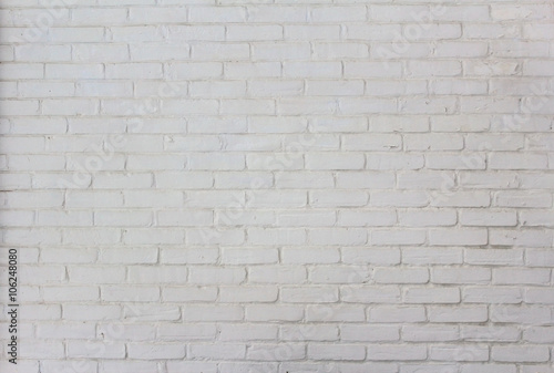 This straight-on shot of white painted brick wall on a historic house shows the building's character.