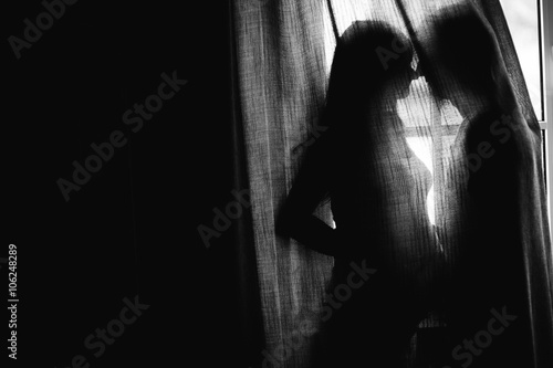 Silhouette beautiful pregnant woman and man holding hands on a c