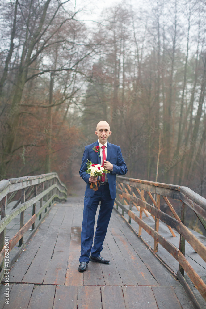 Funny bald groom in a blue suit Funny bald groom in a blue suit