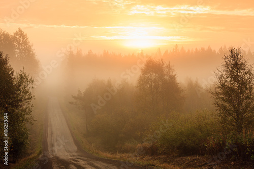 Dirt road and thick fog sunrise