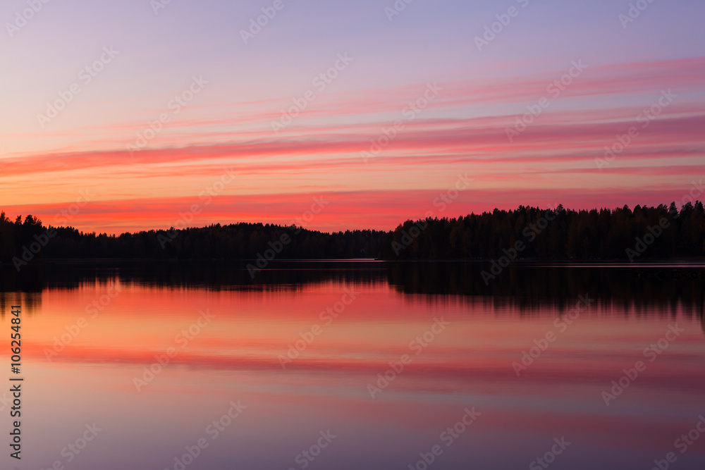 Serene view of calm lake and tree silhouettes