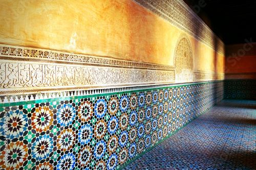 Decorations and shadows of the old Koranic School in Marrakech at sunset photo