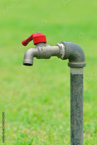 Single faucet on blur green background