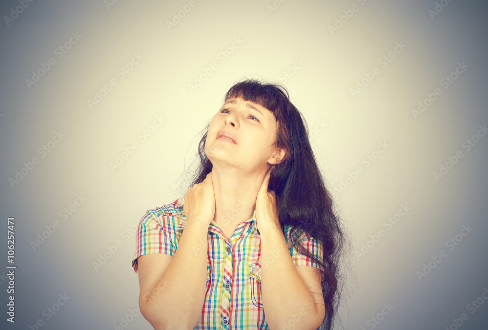 tired woman massaging her painful neck tired woman massaging her painful neck