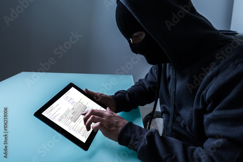 Hacker Stealing Information From Digital Tablet