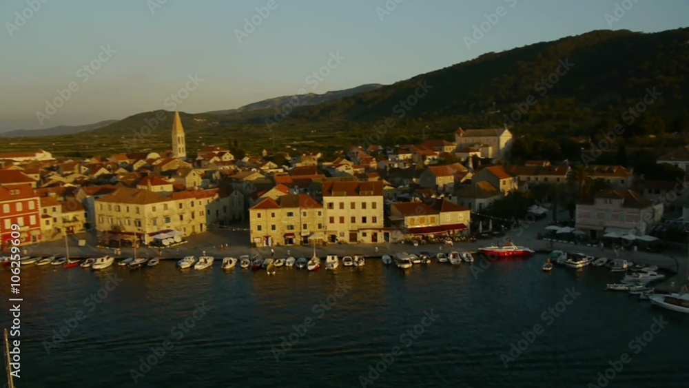 Panning and fly high above through old town marine with anchored sailing boat at sunset.
Panning and fly high above through old town marine with anchored sailing boat at sunset.