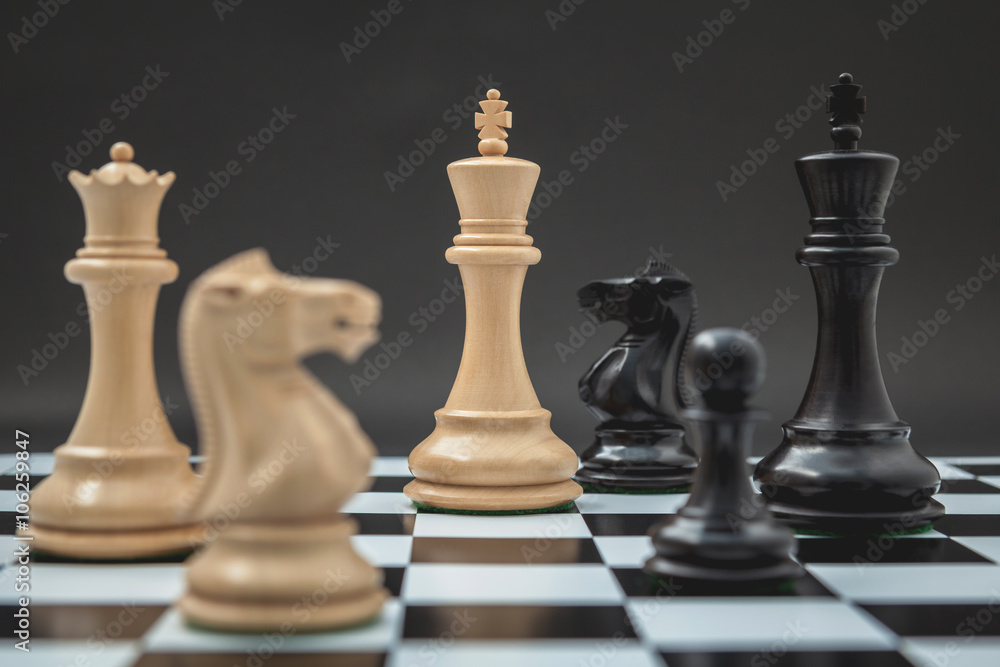 Black and White King and Knight of chess setup on Chessboard and