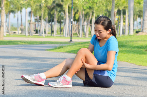 Woman in pain while running in park