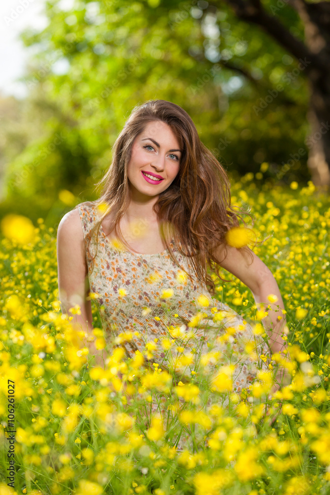 Beautiful young girl among yellow flowers Beautiful young girl among yellow flowers