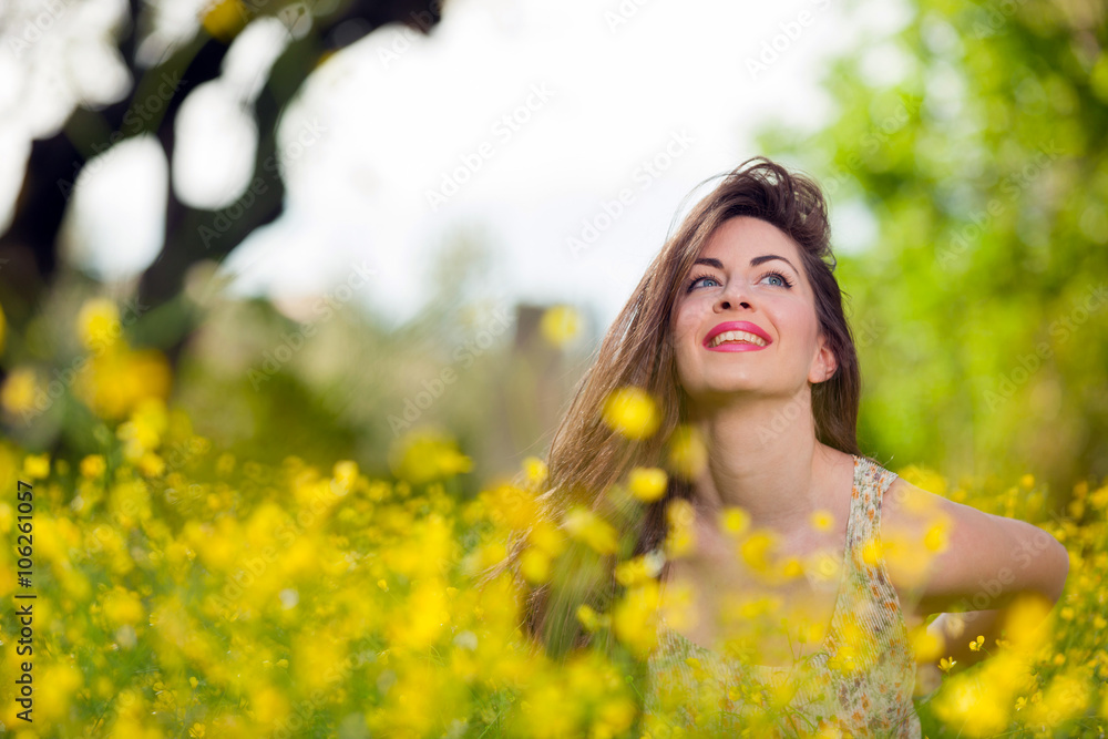 Beautiful young girl among yellow flowers Beautiful young girl among yellow flowers