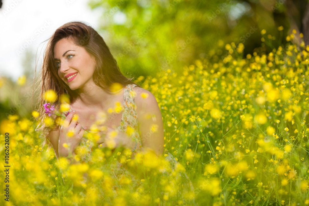 Beautiful young girl among yellow flowers Beautiful young girl among yellow flowers