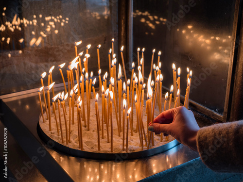 hand holding a candle in a Monastery