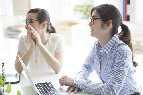 Women who are working in bright office
