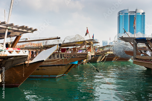 Abu Dhabi buildings skyline with old fishing boats