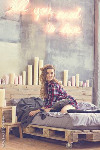 Beautiful woman sitting  on the bed photo