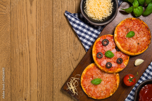 Mix of mini pizzas on wooden board