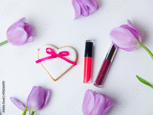 tulip, cookie and lipsticks on the white background
