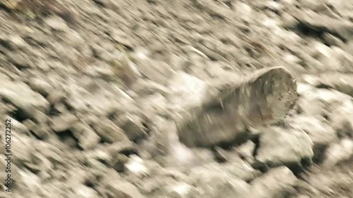Experience the breathtaking slow motion tracking shot of a massive boulder dramatically descending in front of the camera.