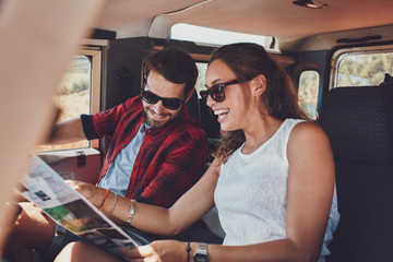 Happy young couple planning their travels