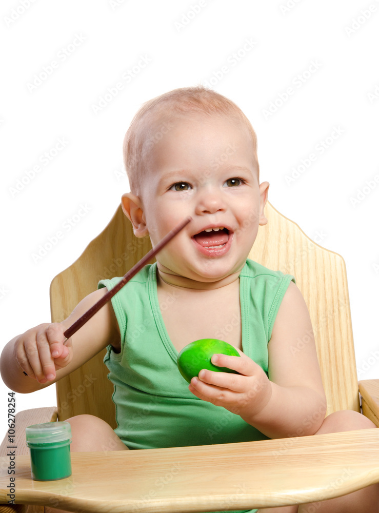 Little boy painting egg isolated on white Little boy painting egg isolated on white