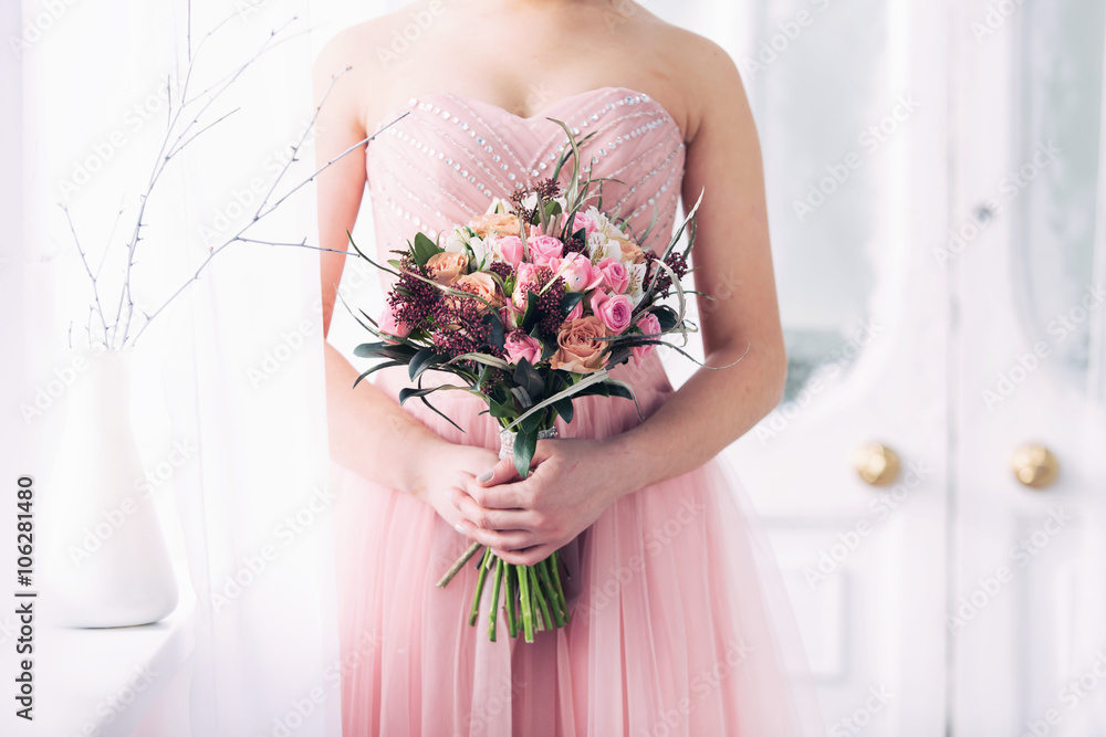 Fototapeta premium bridal bouquet from pink roses in hands