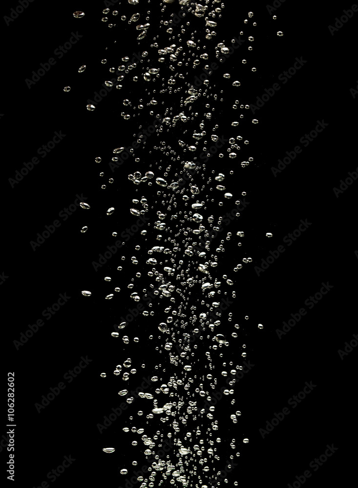 Close up of air bubbles in the water isolated on black backgroun