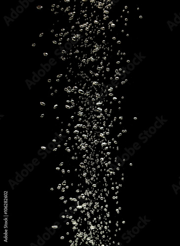 Close up of air bubbles in the water isolated on black backgroun