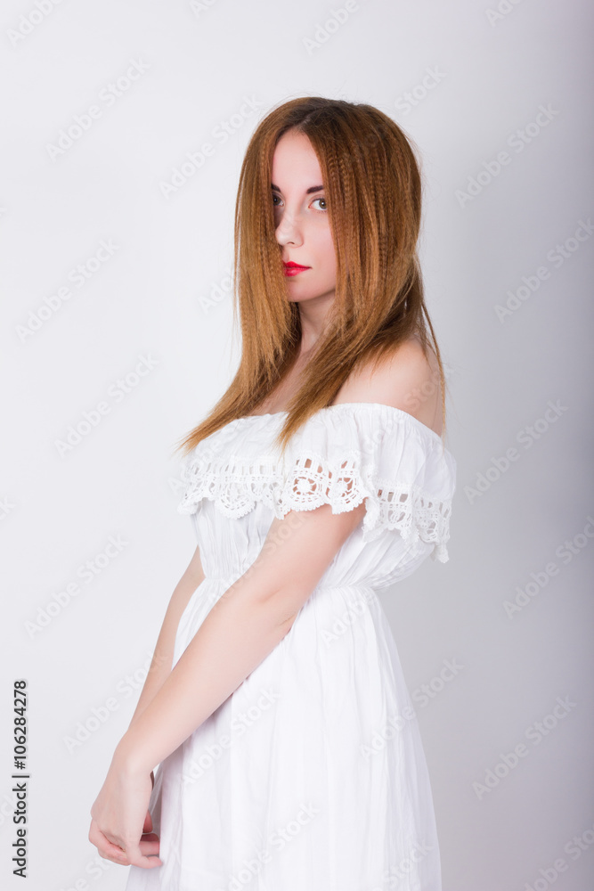 Beautiful slim girl in a small white lace dress posing Beautiful slim girl in a small white lace dress posing