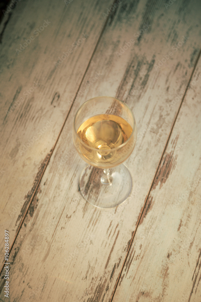glass with white wine in vineyard on old table glass with white wine in vineyard on old table