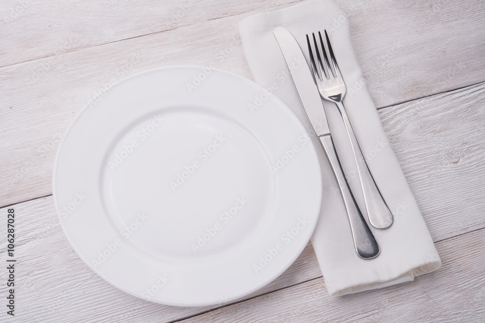white plate, knife and fork