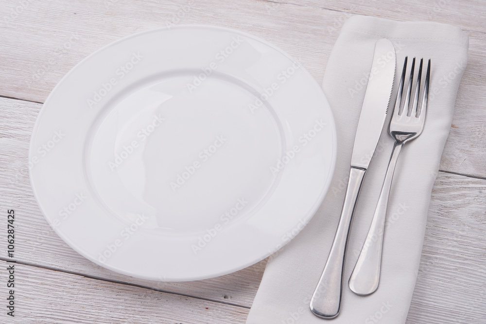 white plate, knife and fork