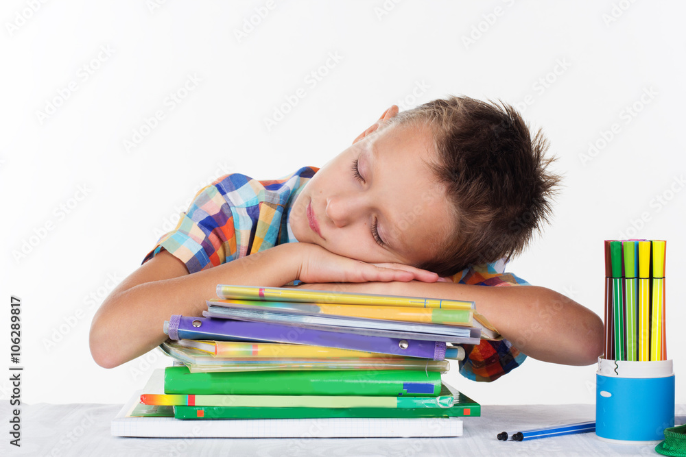 Cute school boy is dreaming on books Cute school boy is dreaming on books