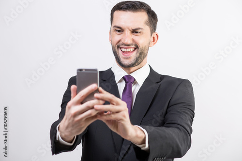 Young business man taking a selfie