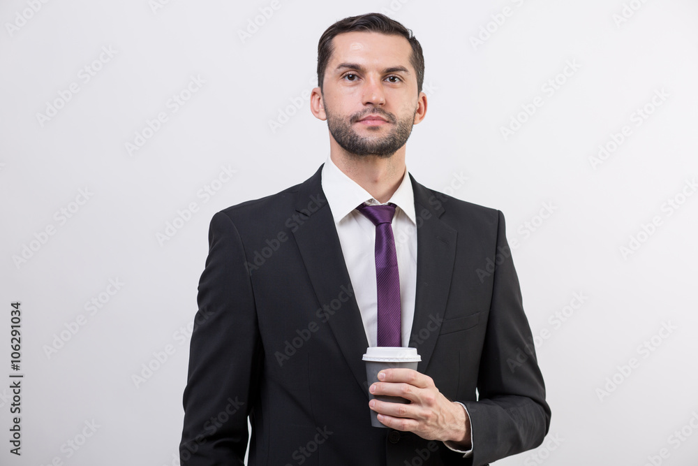 Young businessman holds coffee cup Young businessman holds coffee cup