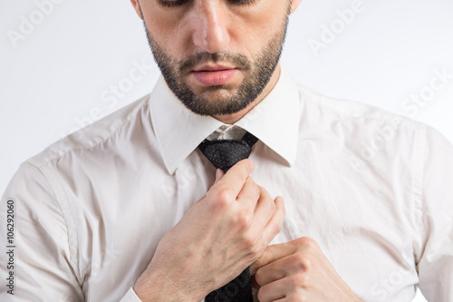 Man ties a necktie knot