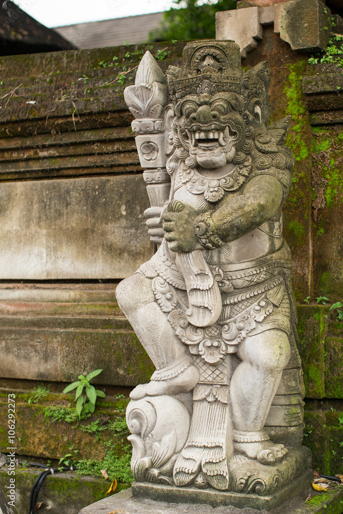 Traditional demon guard statue carved in stone on Bali, Indonesia.