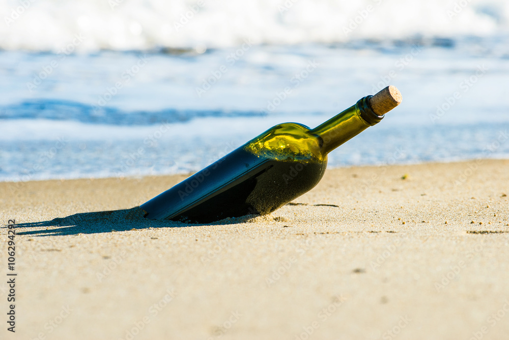 Romantic picnic with glasses of red wine sitting on the beach at the summer sunny day. Waves and sea on the background Romantic picnic with glasses of red wine sitting on the beach at the summer sunny day. Waves and sea on the background
